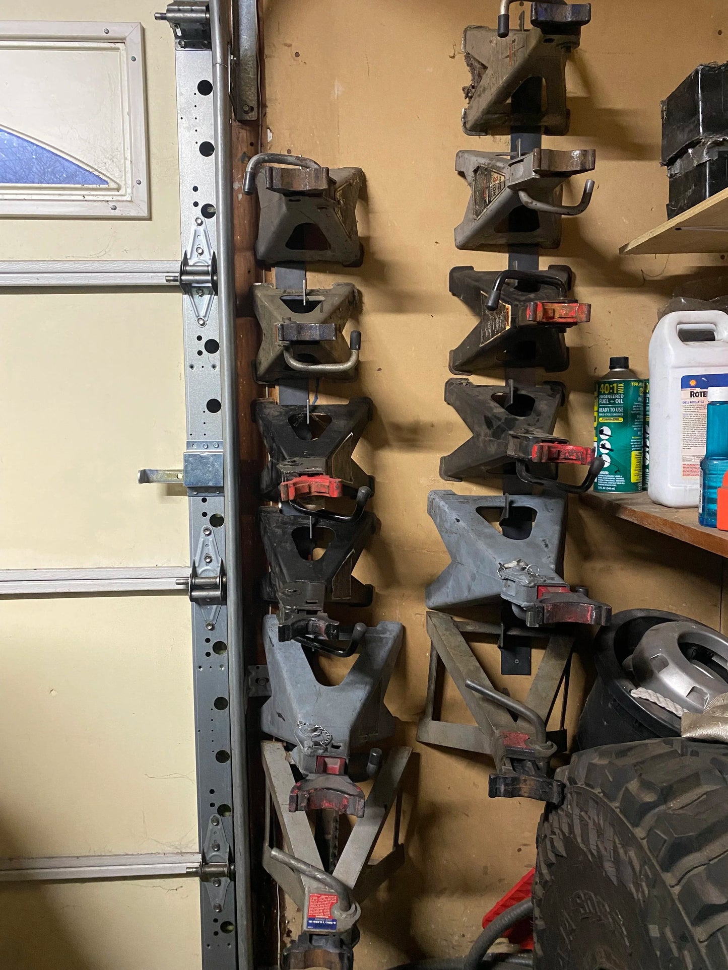 12 jack stands hanging on the wall in Nick's personal garage using 4Link4WD jack stand hangers. It has been years of convenient storage! 