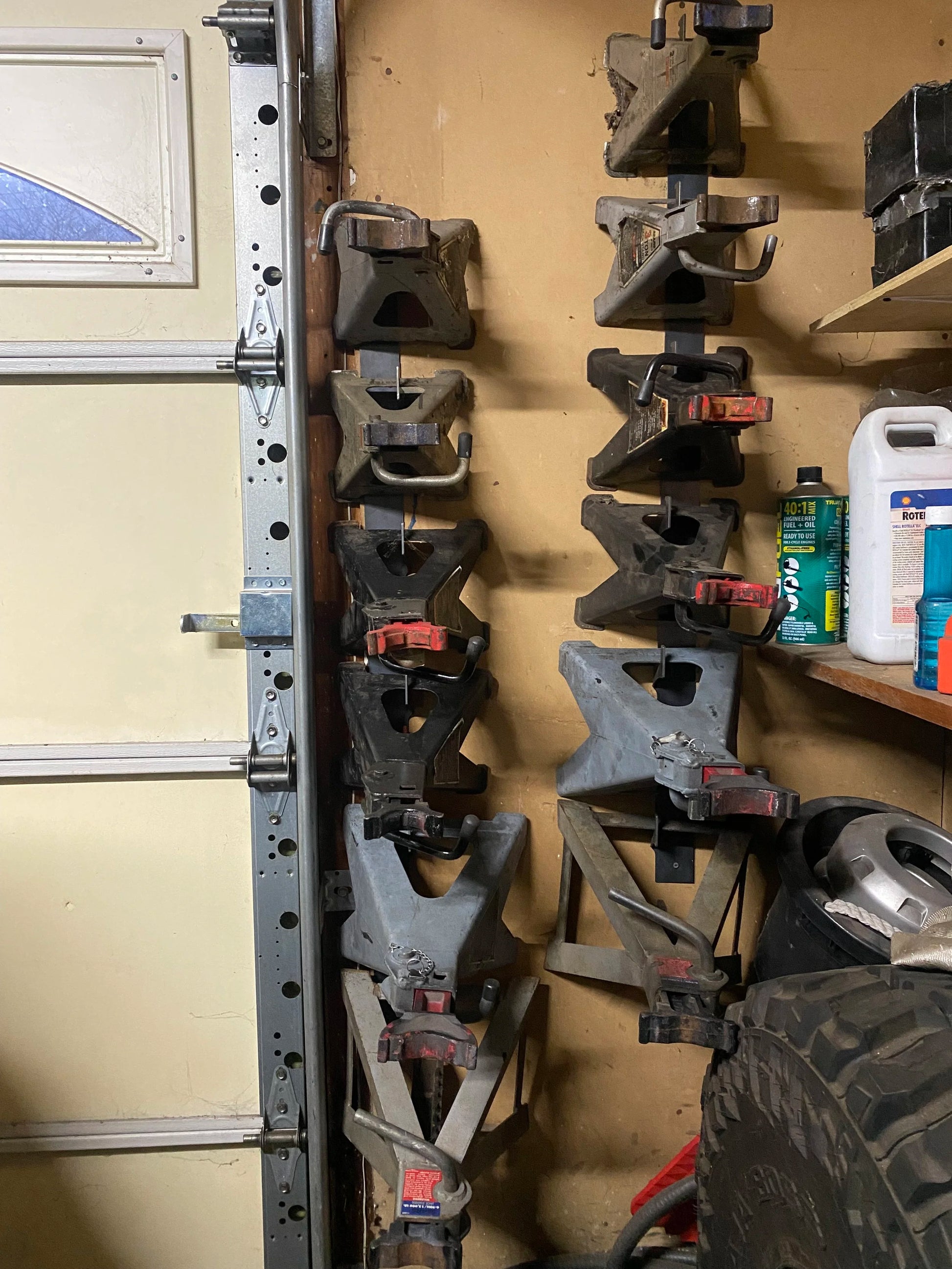 12 jack stands hanging on the wall in Nick's personal garage using 4Link4WD jack stand hangers. It has been years of convenient storage! 