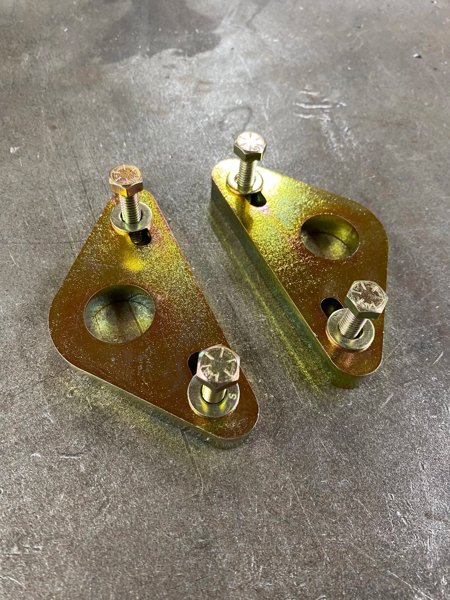 4Link4WD case spreader adapters showing off gold zinc plating. 
